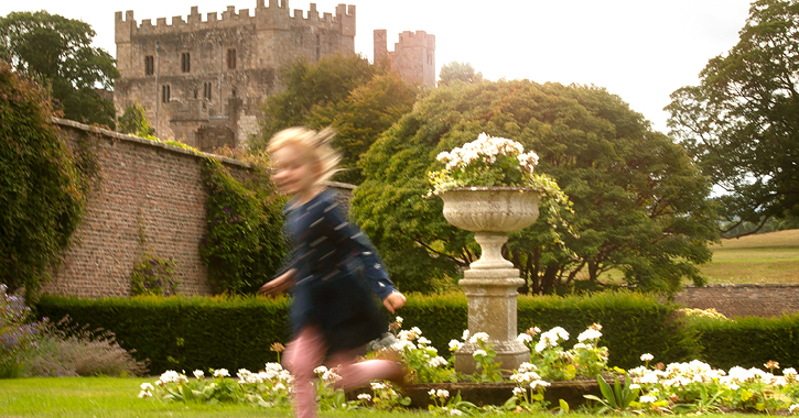 little girl running through the medieval walled garden at Raby Castle